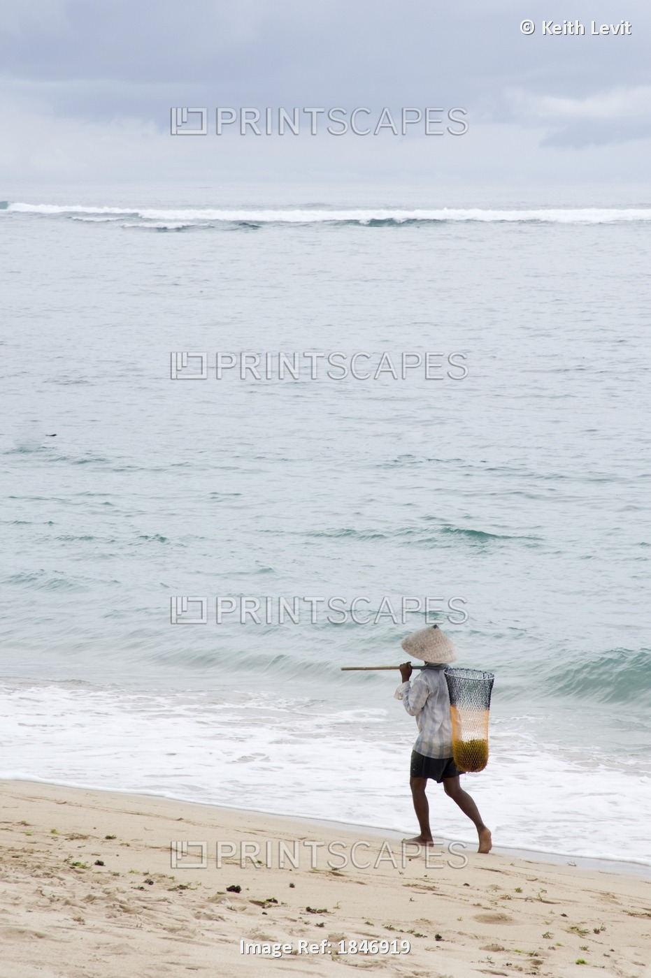 Person Walking On Beach With Fishing Net; Bali,Indonesia