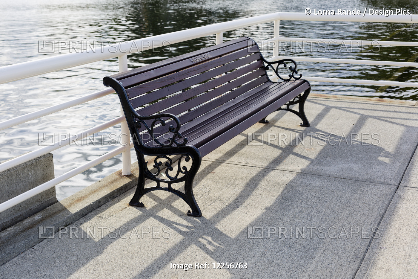 A Bench Beside A Railing At The Water's Edge; Nanaimo, British Columbia, Canada