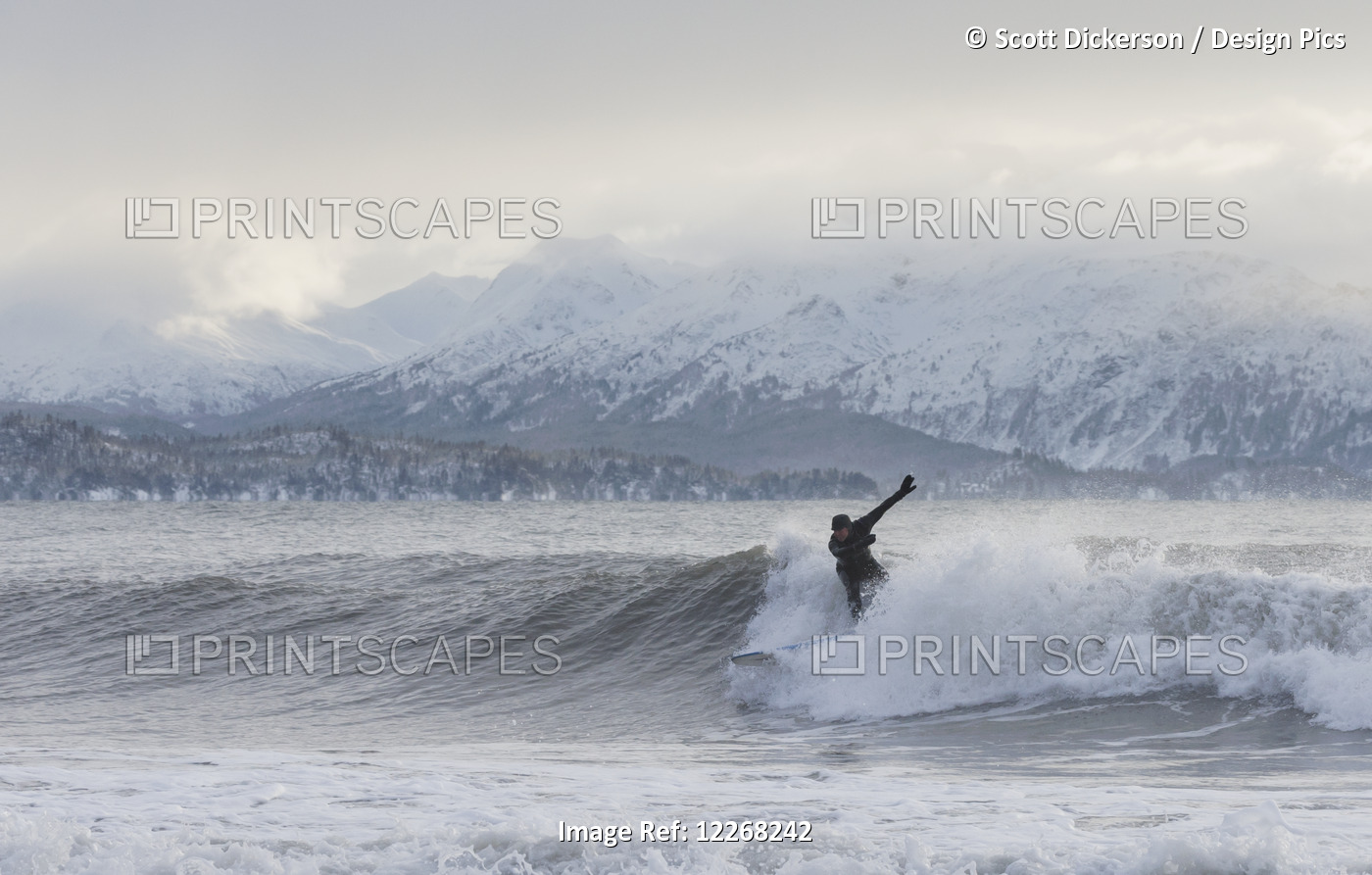 Person Surfing In Winter In Homer, Kenai Peninsula, Kachemak Bay, Alaska.