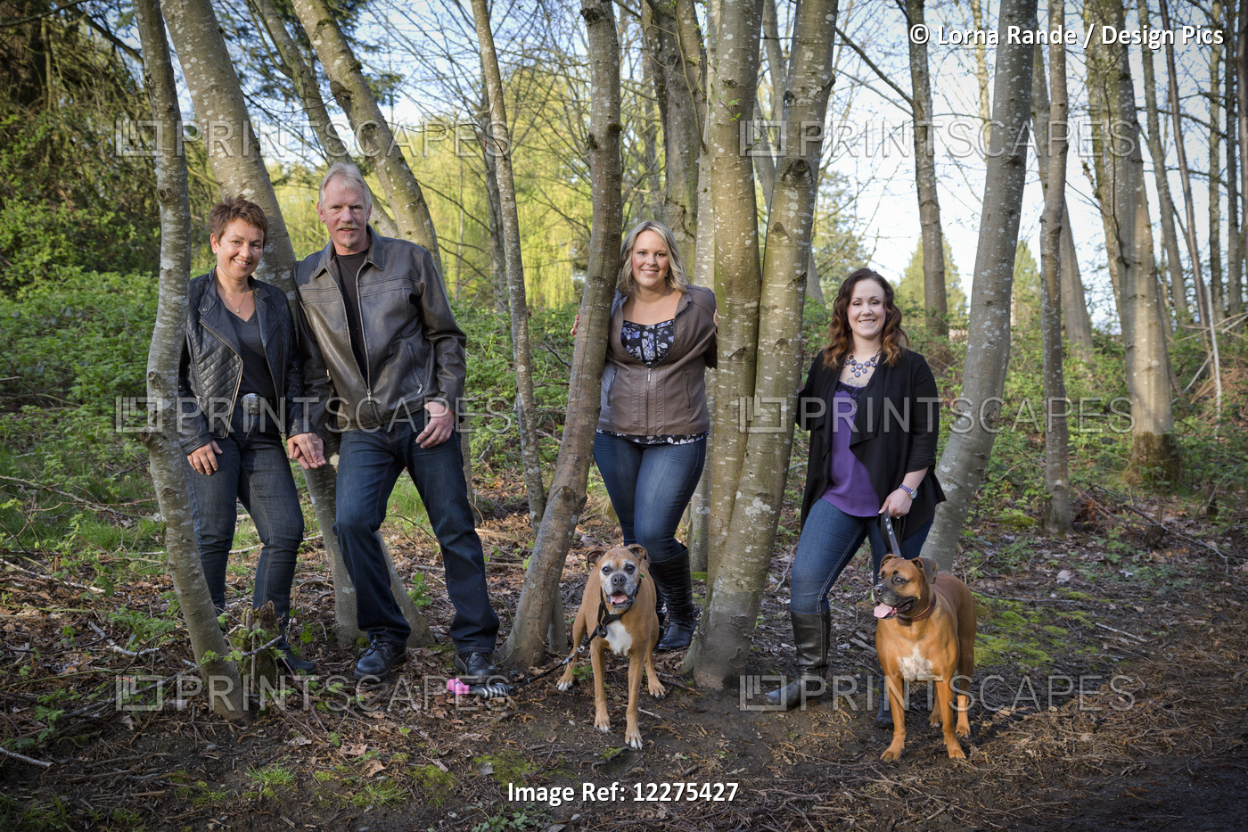 Portrait Of A Family With Two Daughters And Two Dogs; British Columbia, Canada