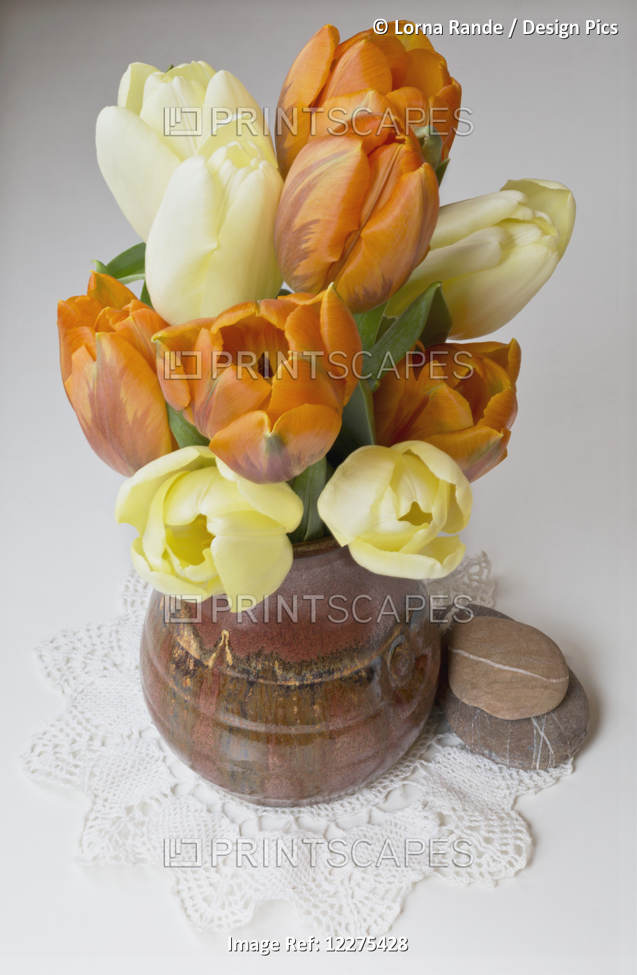 Yellow And Orange Tulips In A Ceramic Vase; British Columbia, Canada