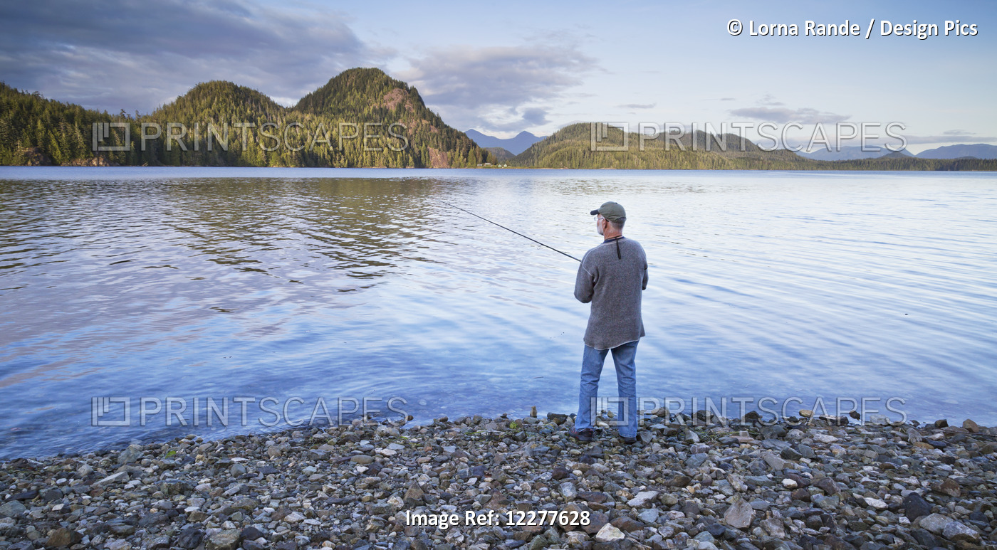 Man Fishing On The Shore Of Grice Bay, Pacific National Park; Vancouver Island, ...