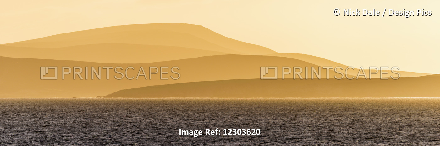 Sunrise Over Orange Hills And Blue Ocean; Antarctica