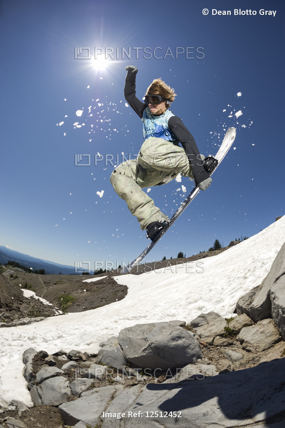 A professional, freeriding snowboarder mid-air on Mount Hood; Oregon, United ...