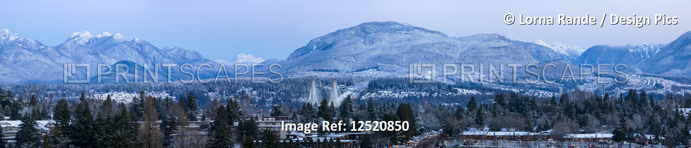 Panoramic of snowy Cascade mountain range with the town of Surrey in the ...
