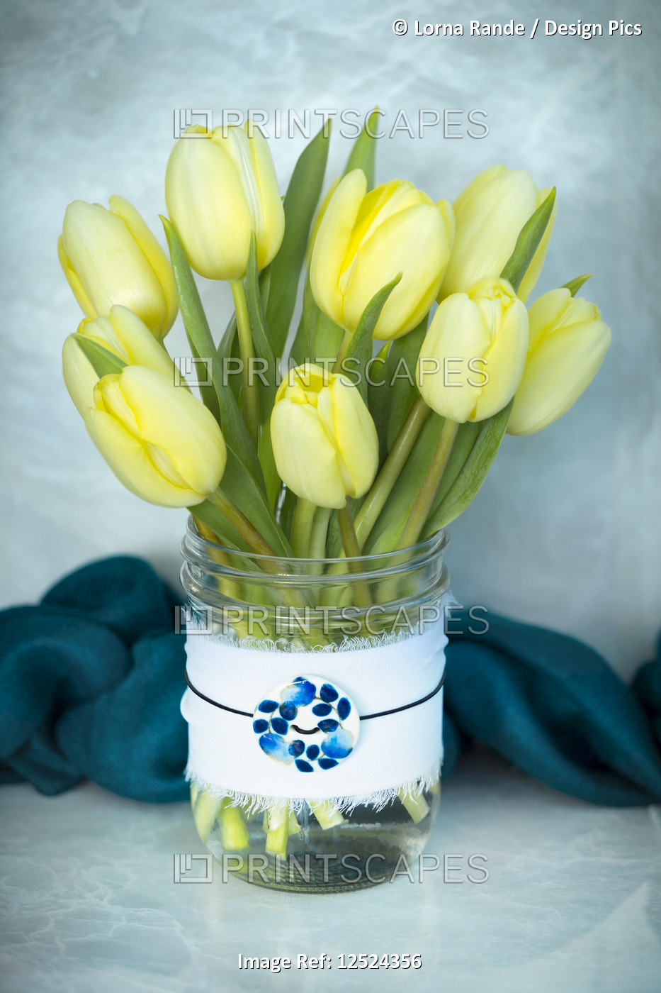 Cut tulips in a decorative glass jar with a pendant