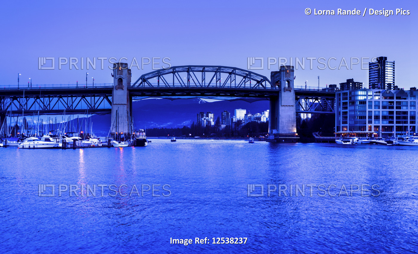 Bridge over False Creek in the harbour at Granville Island during blue hour; ...