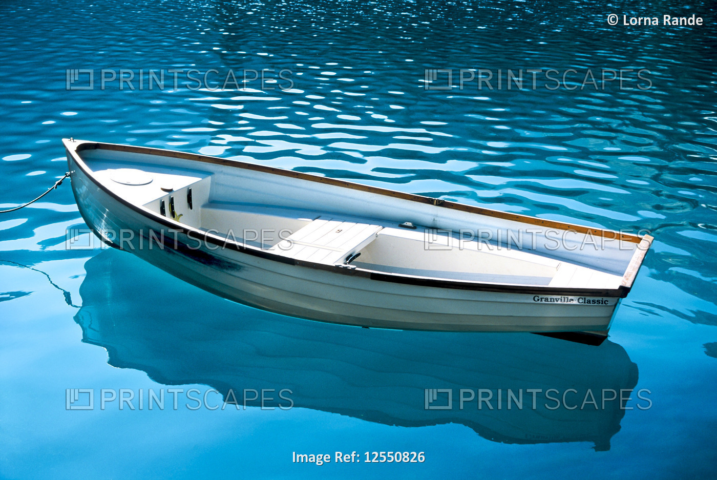Boat floating on the glacial water of Lake O;Hara in Yoho National Park, BC. ...