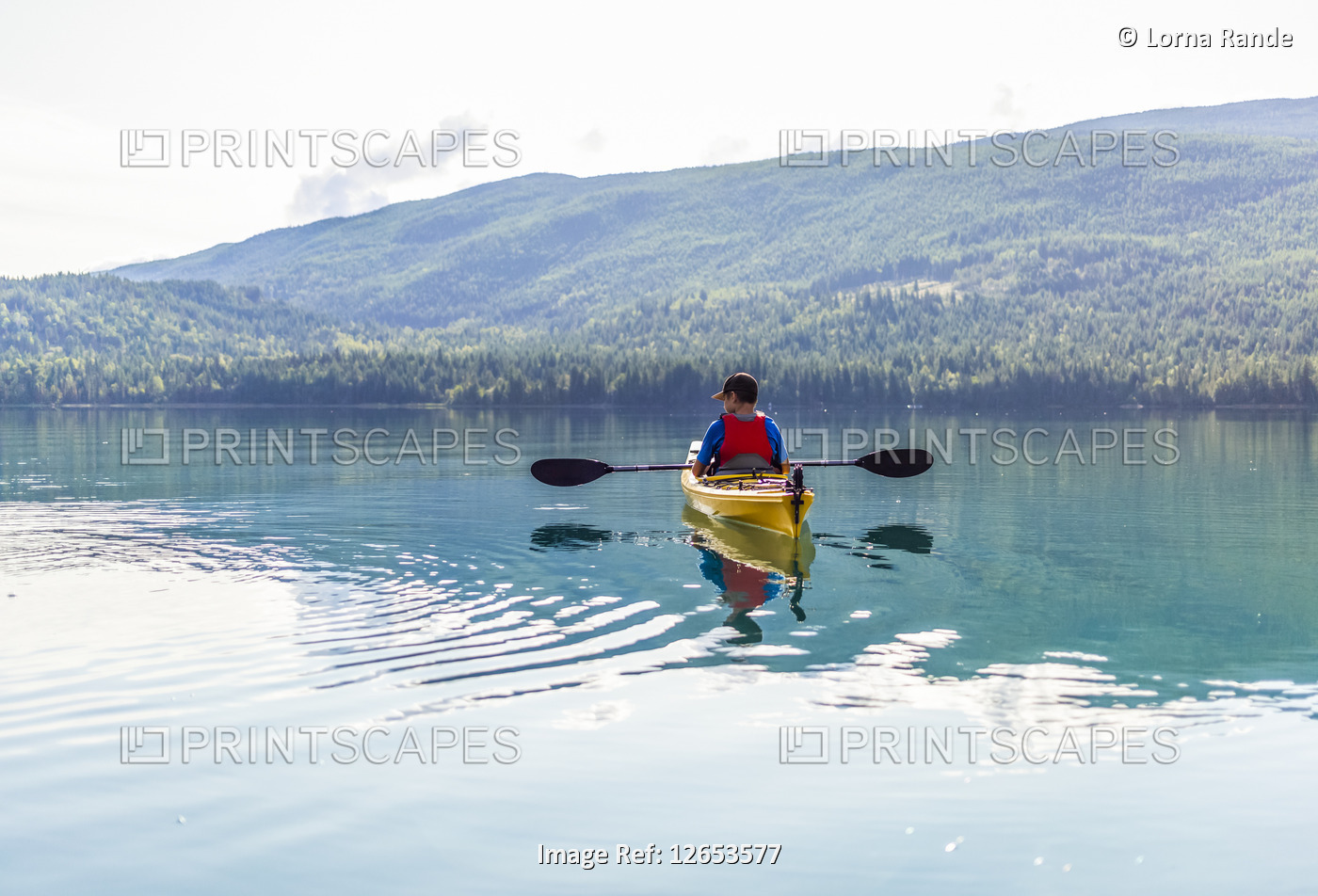 A teenage boy kayaking on White Lake, White Lake Provincial Park; British ...