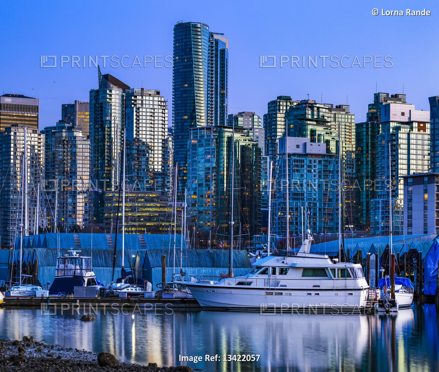 Boats mooring in a tranquil harbour at twilight; Vancouver, British Columbia, ...