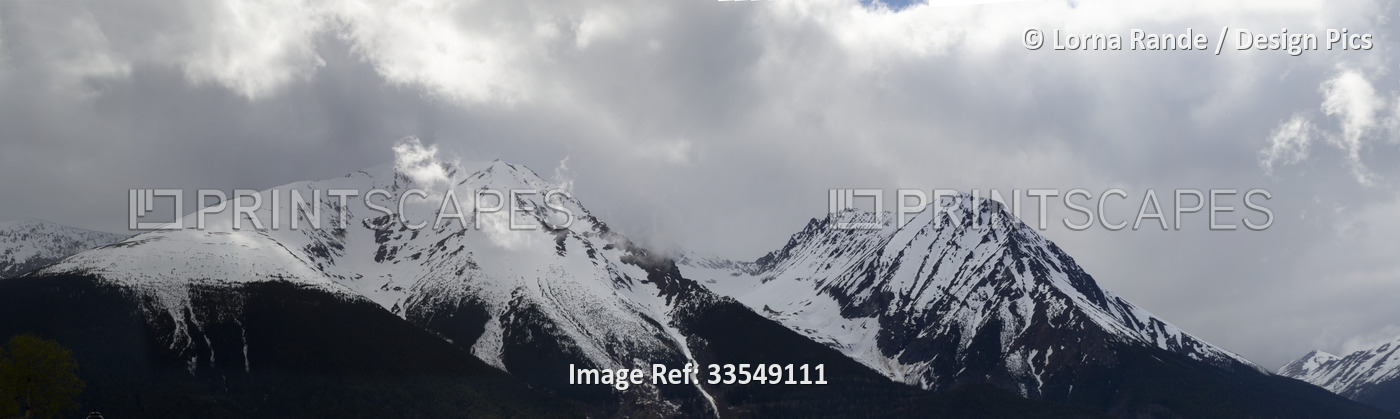 Rugged peak of Hudson Bay Mountain covered in snow; Smithers, British Columbia, ...