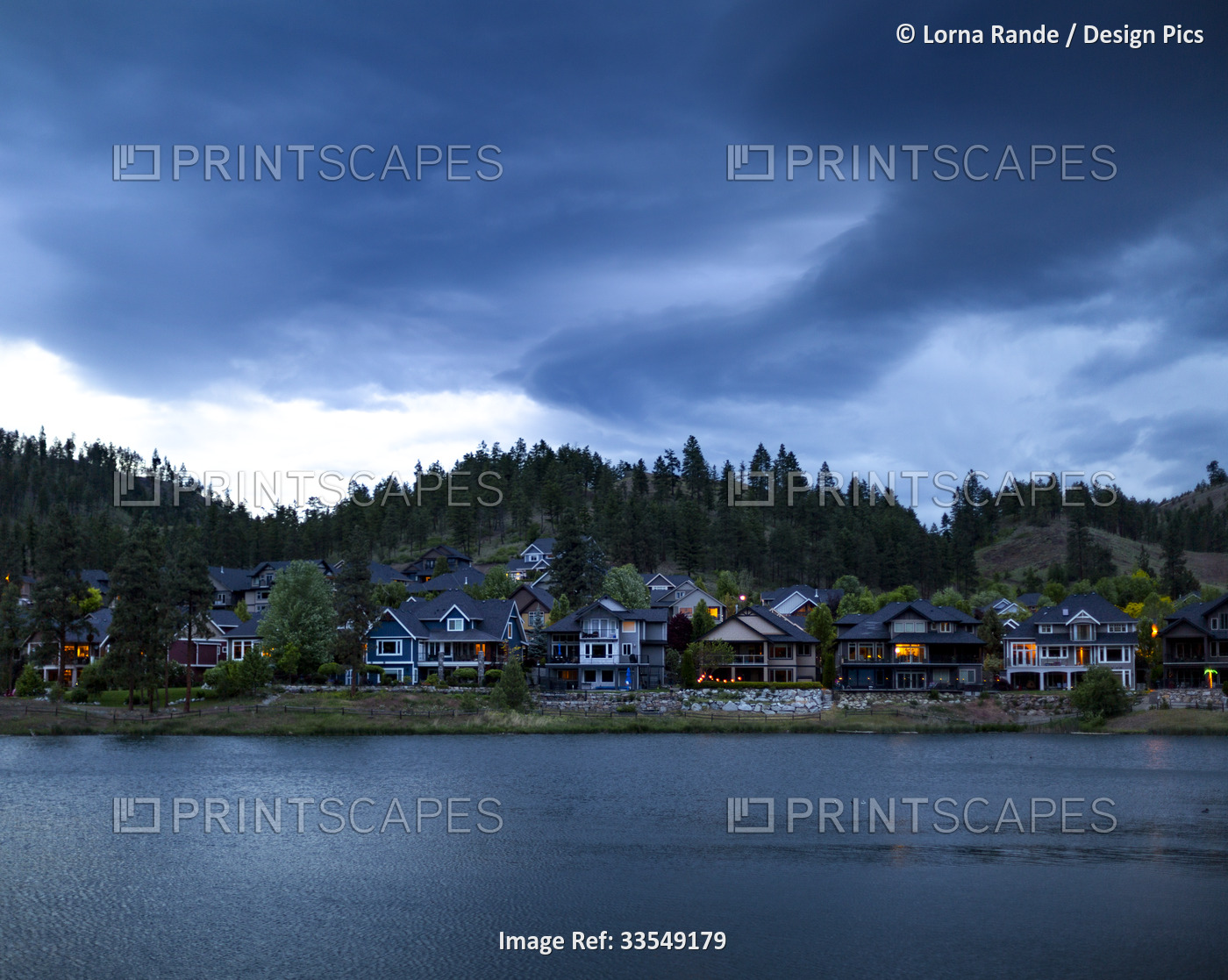 Housing in a community around Still Pond at twilight in Kelowna, BC, Canada; ...