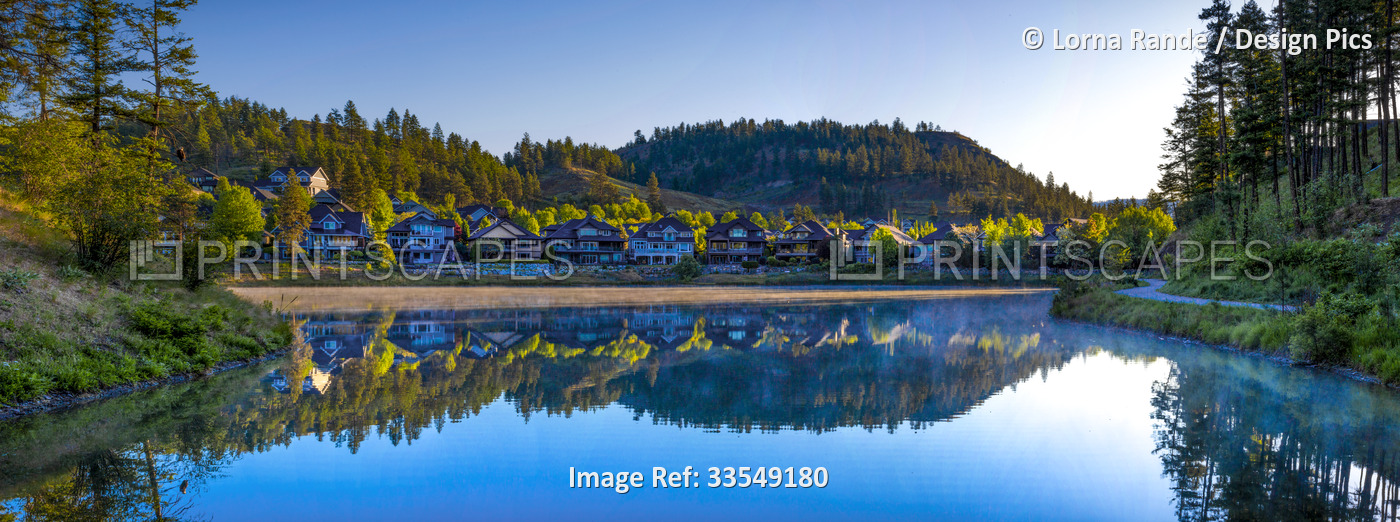 Housing in a community around Still Pond at sunrise in Kelowna, BC, Canada; ...