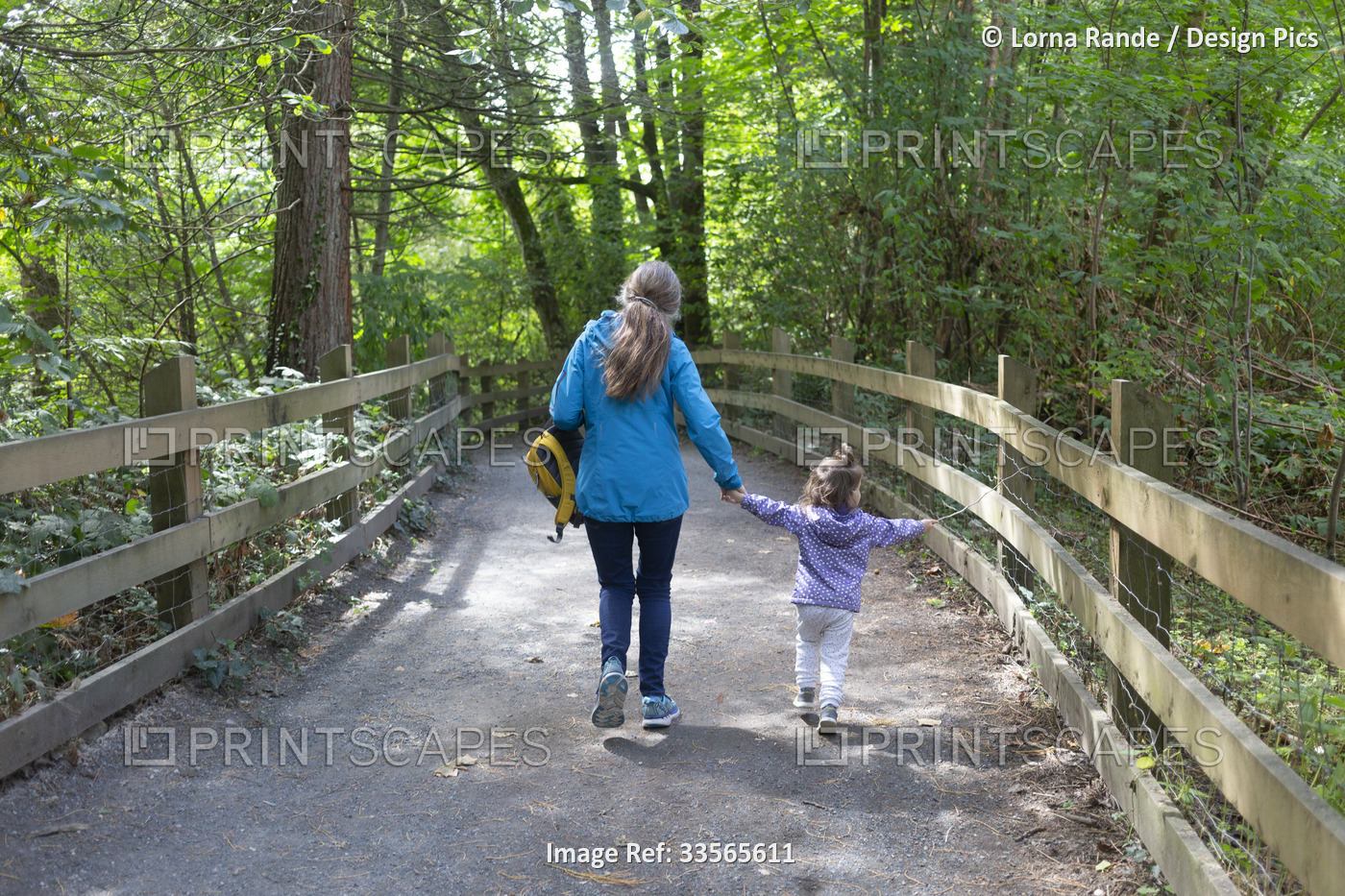 Grandmother and granddaughter having an adventure, holding hands and walking ...