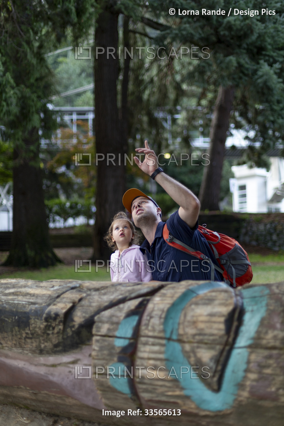 Father with his young daughter pause to explore nature, Horseshoe Bay, BC, ...