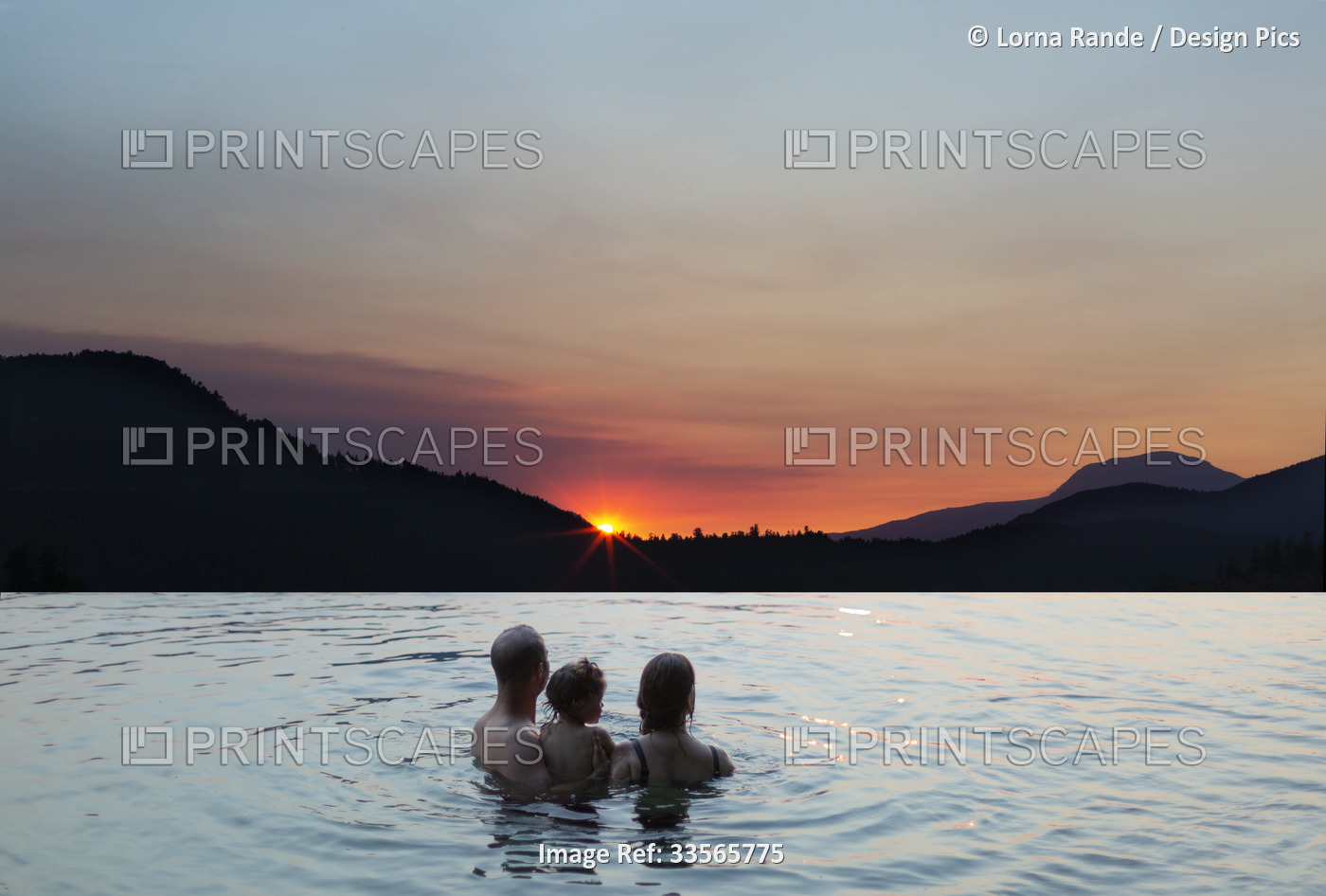 Young family watching a sunset while swimming in a lake, Ruby Lake on the ...