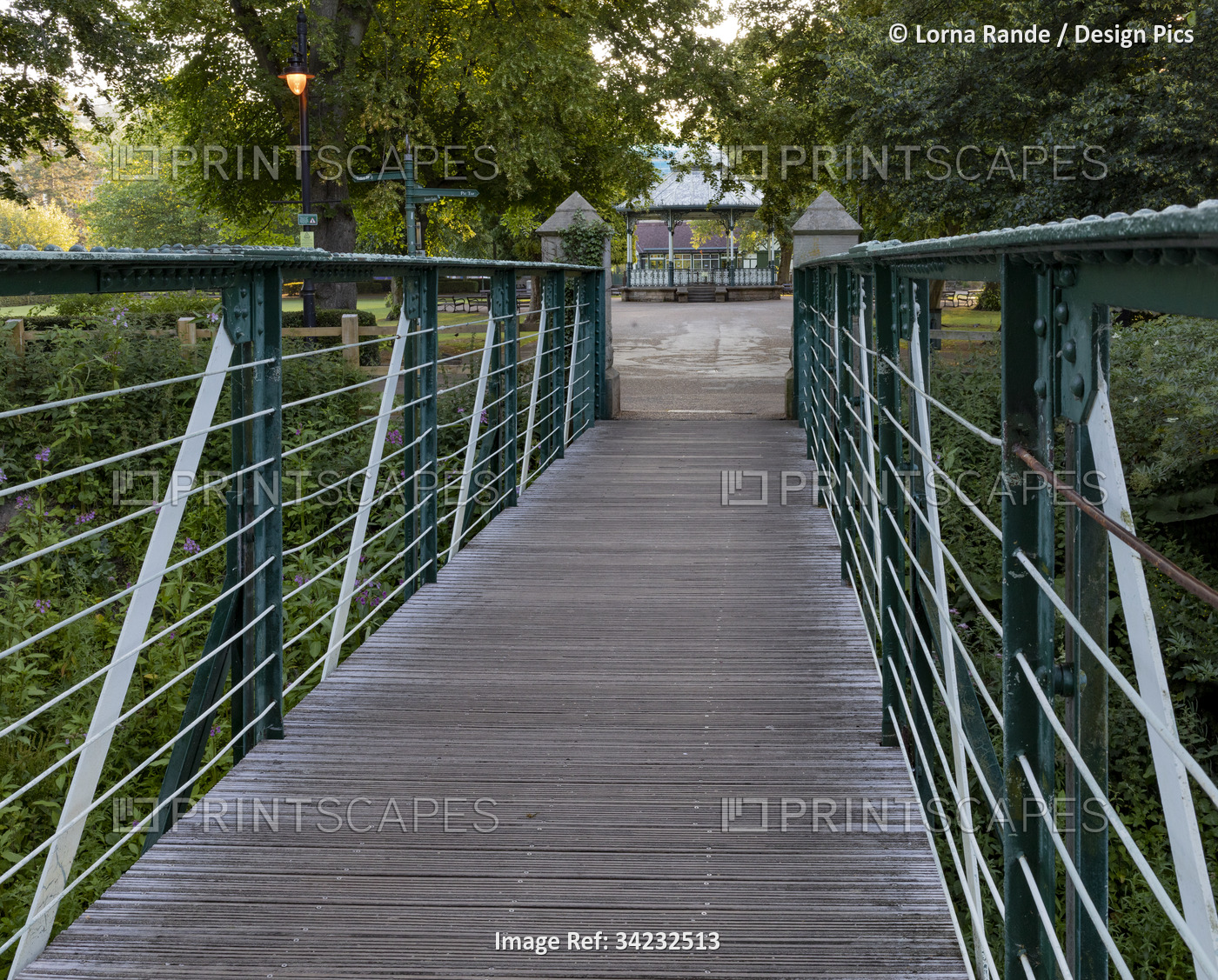 Walkway across River Derwent with a view of the bandstand in Hall Leys Park in ...