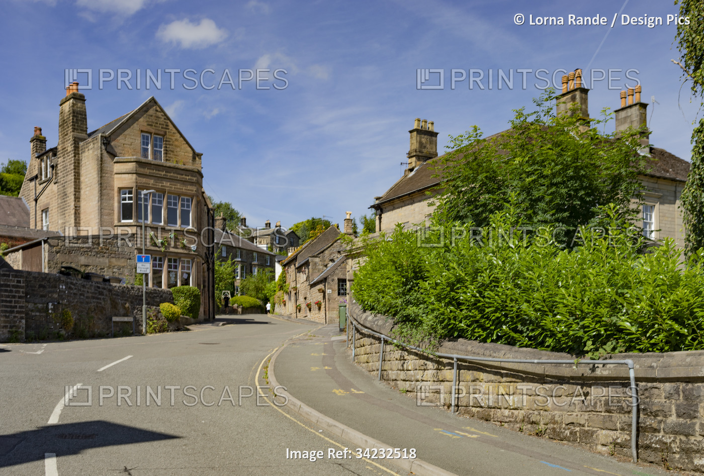 Street winding uphill in a neighbourhood in Matlock, Derbyshire, UK; Matlock, ...