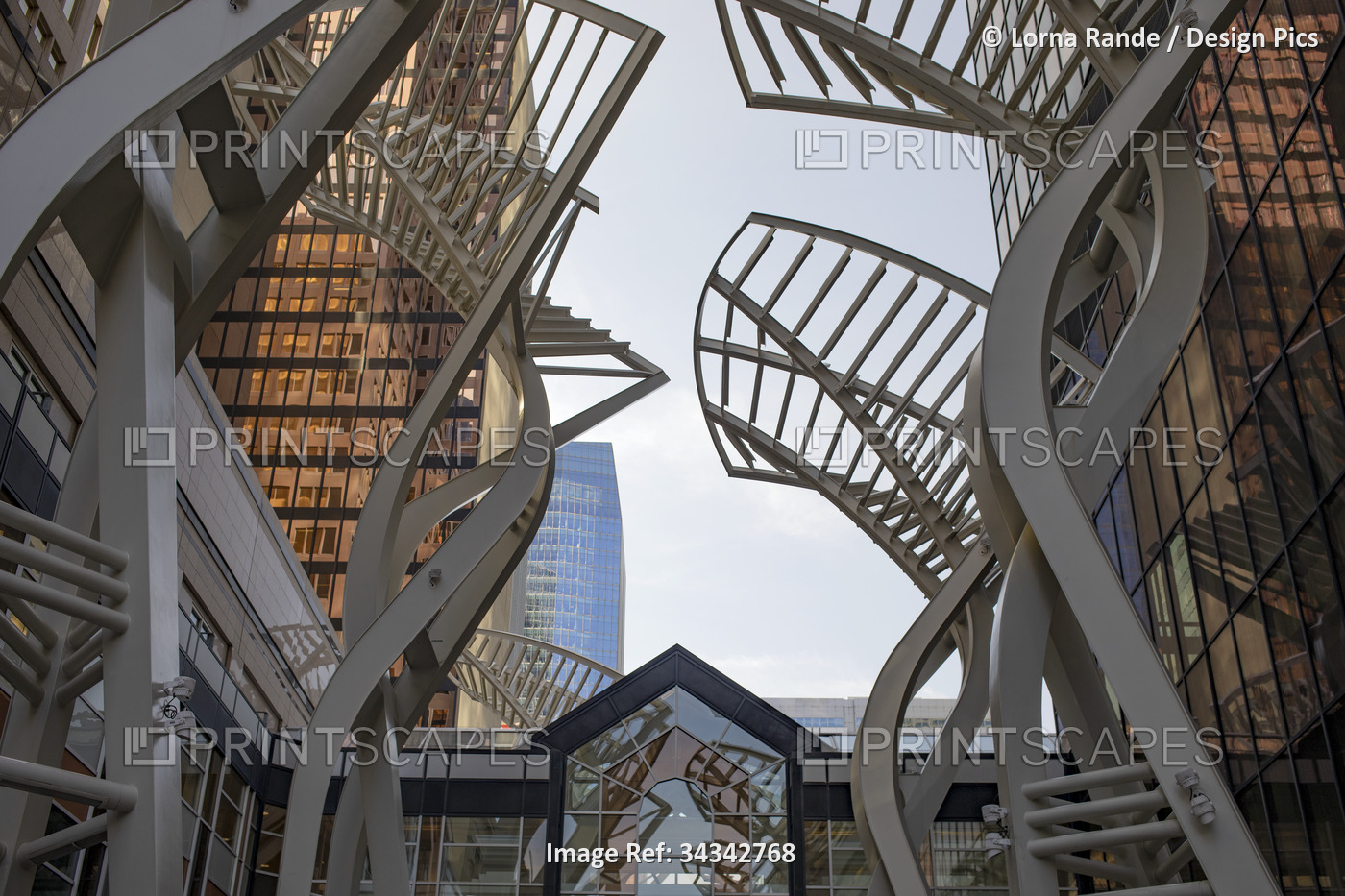 Low angle view of public art sculptures made of metal, and skyscrapers in the ...
