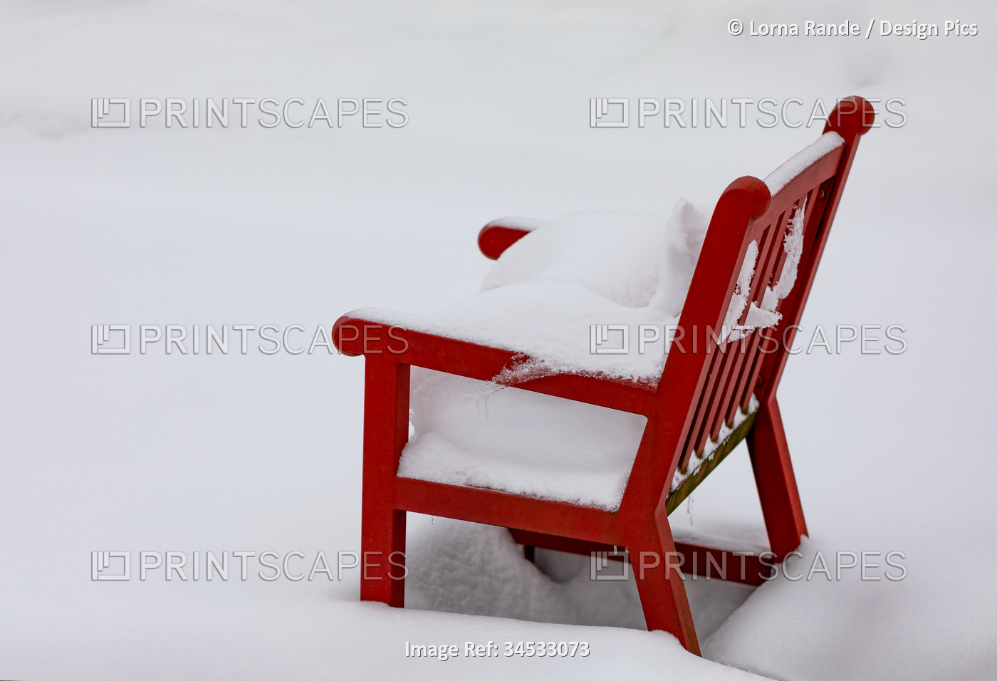 Red outdoor chair covered in deep snow; Surrey, British Columbia, Canada
