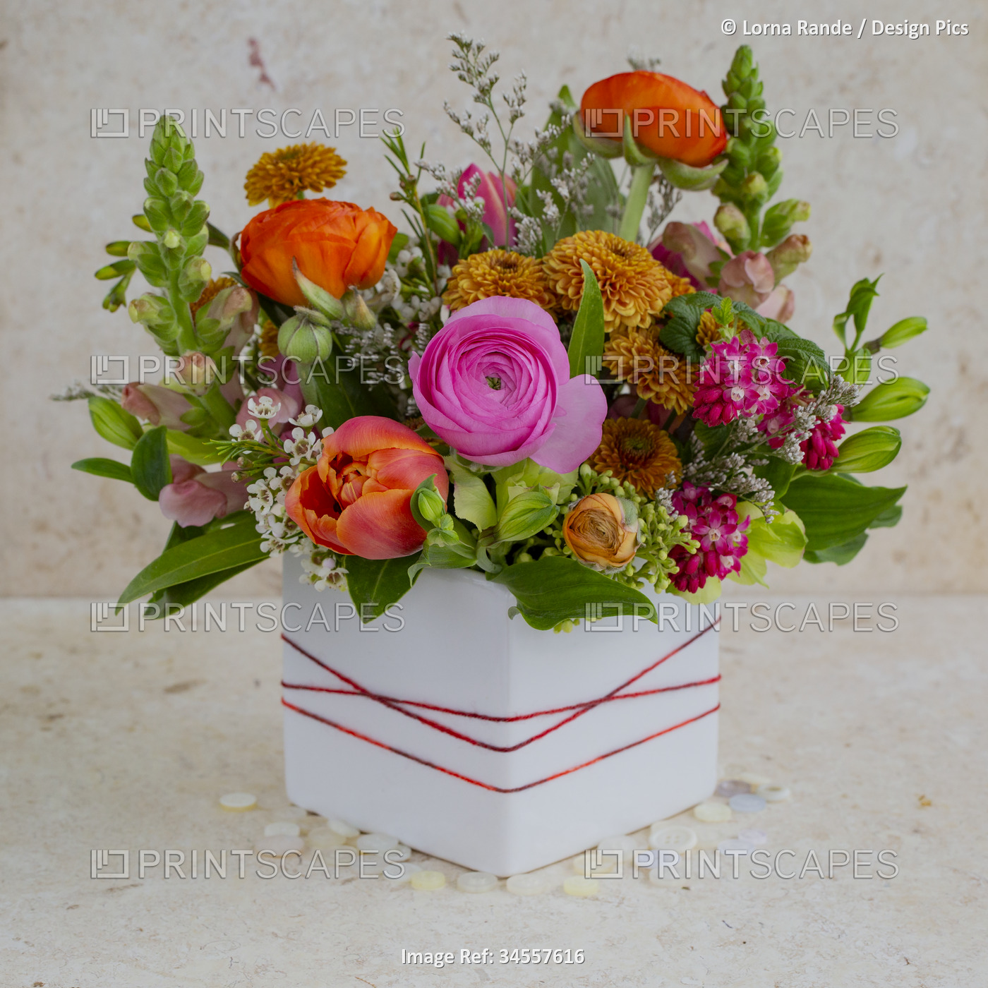 Colorful floral arrangement in square vase; Studio Shot